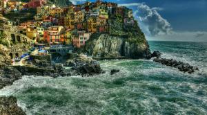 a view of a town on the side of a mountain at The Sea View Attic in Manarola