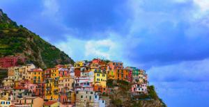 a bunch of houses on a hill with a sky at The Sea View Attic in Manarola