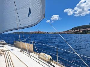 a sail on a boat on a body of water at Jedrilica PERUN in Kravlja