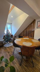Appartement atypique au cœur de Sallanches في سالونش: غرفة طعام مع طاولة وشجرة عيد الميلاد