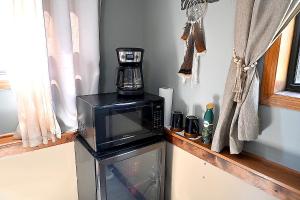 a coffee maker is sitting on top of a microwave at Hotel Oasis with Outdoor Kitchen in Fall River