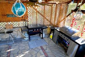 an outdoor kitchen with a stove and a grill at Hotel Oasis with Outdoor Kitchen in Fall River