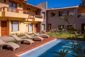 a house with a swimming pool next to a house at KALLPA WARMI Hotel Panoramico in Tilcara