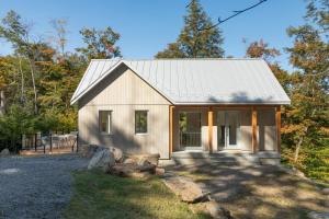 a small house with a metal roof at Maison Solus - Mont Tremblant in Lac-Superieur