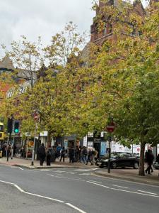 a group of people walking on a city street at PICCADILLY Private room and bathroom in Manchester +5 photos