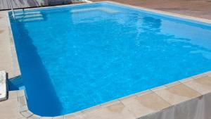 a large blue swimming pool with blue water at Marsden Stay Rotorua in Rotorua