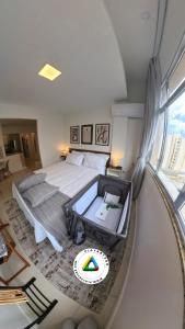 a bedroom with a large bed and a large window at Studio 929 Gold Star 400m Ferry to Rio 1Gb Wi-Fi in Niterói +25 photos