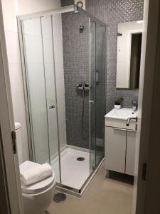 a bathroom with a shower and a toilet and a sink at Pátio Da Gata in Coimbra +43 photos