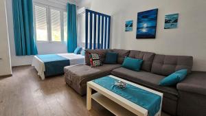 a living room with a couch and a bed at Zero Distance Studio in Podgorica