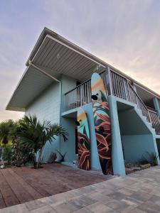 a building with a mural of surfboards on the side of it at 400 South - Unit G in Cocoa Beach