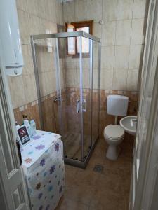 a bathroom with a shower with a toilet and a sink at Guest House Prilep in Prilep