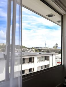 an open window with a view of a building at Noa Hotel in Auckland