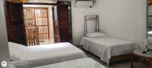 Ένα ή περισσότερα κρεβάτια σε δωμάτιο στο Hostal Casa de las Americas