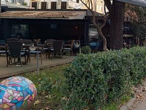 a ball sitting in the grass next to some tables and chairs at White Lounge Haustor in Podgorica +50 photos