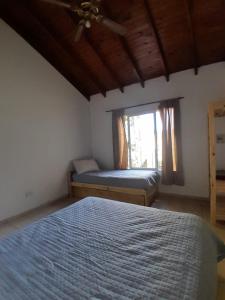 ein Schlafzimmer mit einem Bett und einem Fenster in der Unterkunft Casa Las Marías in General Belgrano