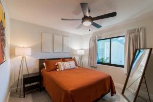 een slaapkamer met een bed en een plafondventilator bij Full complex 8 Separate 2 bedroom 1 bath units in Cocoa Beach