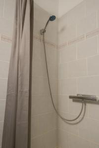 a shower with a shower curtain in a bathroom at Hotel Amager in Copenhagen +34 photos