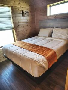 una camera da letto con un grande letto in una camera in legno di Bryan North College Station KOA Holiday a Bryan