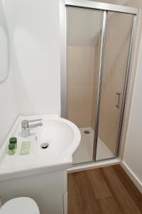a bathroom with a white sink and a shower at City Stays Norwich in Norwich