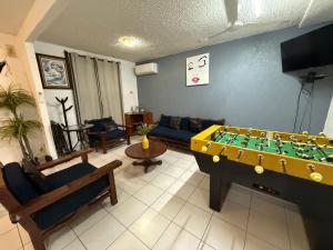 a living room with a pool table and a couch at Casa Morroken Ixtapa con Alberca in Ixtapa