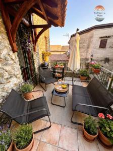a patio with chairs and a table and an umbrella at TraMonti e Mare in Scalea