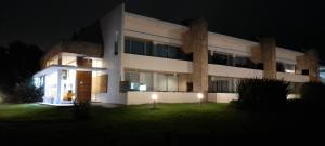 a large white building with two lights in front of it at Apartmento, Punta 30 Complejo in Mar Azul