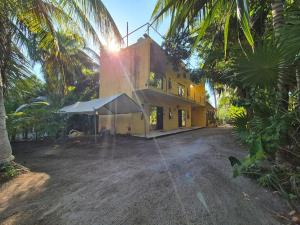 a building with a tent in front of it at Casa Tio 1,quiet ground floor apartment in El Cuyo