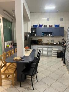a kitchen with a table and chairs in a kitchen at Casa Mirante do Mar Floripa in Florianópolis