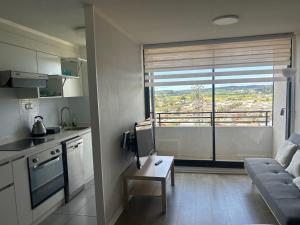 康塞普西翁Dpto Concepción Amoblado的厨房和带大窗户的客厅