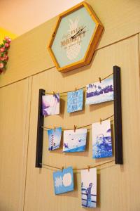 a bulletin board with pictures on a wall at Wind Residences For Rent - Luiice in Tagaytay +90 photos