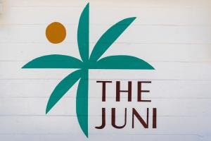 a sign that says the juir on a wall at The Juni-7 Unit Renovated Complex in Cocoa Beach