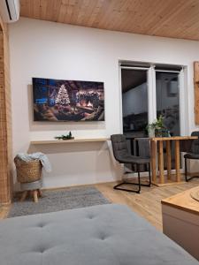 a living room with a tv on the wall at Domeček Sára in Mohelnice