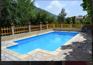 a swimming pool in a backyard with a fence at Chez antho chambres et table d hôtes in Betton-Bettonet