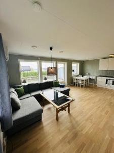 a living room with a couch and a table at Nydelig perle ved Tyrifjorden 