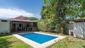 a swimming pool in the yard of a house at Pura Vida Villa! Beachfront Golf and Country Club Los Delfines 24 hours security in Tambor