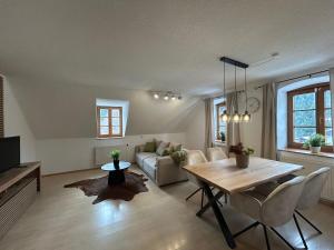 un soggiorno con un tavolo e un divano di Faraway Homes Studios Bad Leonfelden a Haid