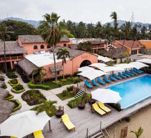 an aerial view of a resort with a swimming pool and umbrellas at La Posada Hotel Boutique in Manzanillo