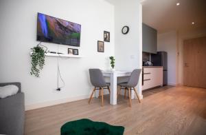 a living room with a white table and chairs at BW Gallery in Belgrade +3 photos