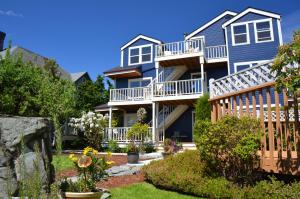 a blue house with balconies and a yard at The Heron Inn and Day Spa in La Conner