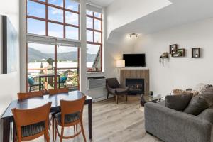 a living room with a table and a couch at Alpenglow Lodge Junior Penthouse by MVA in Whistler