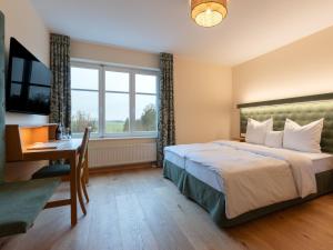 Ένα ή περισσότερα κρεβάτια σε δωμάτιο στο Gutshotel Odelzhausen