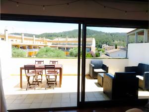un patio con tavolo e sedie su un balcone di Casa rural de estilo rústico a Bonastre