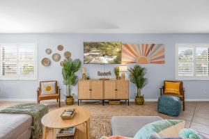 a living room with a couch and a table at Downtown Cocoa Beach Townhome- Walk to Everything in Cocoa Beach +25 photos