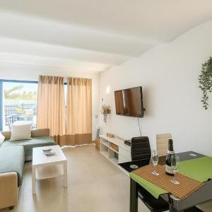 a living room with a couch and a table at A Dream On The Beach Sun Club in Playa del Aguila