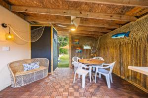 a patio with a table and chairs on a patio at Island Escape w Private Pool & Outdoor Haven in Merritt Island