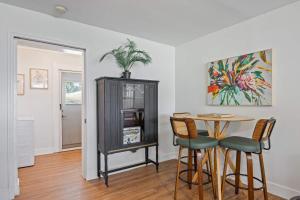 a dining room with a table and a cabinet at Island Escape w Private Pool & Outdoor Haven in Merritt Island