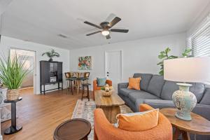 a living room with a couch and a table at Island Escape w Private Pool & Outdoor Haven in Merritt Island +27 photos