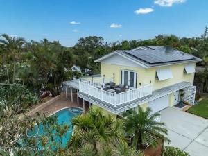 an aerial view of a house with a swimming pool at 4BR 2-5BA Waterfront Oasis w Pool and Dock in Cocoa Beach