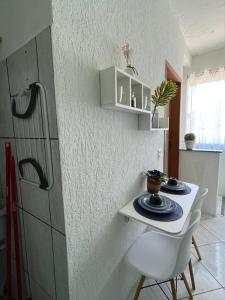 a kitchen with a small table and a refrigerator at Sobradinho da Lagoa in Niterói +42 photos