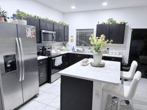 a kitchen with stainless steel appliances and a white counter top at Close to Florida Keys in Florida City
